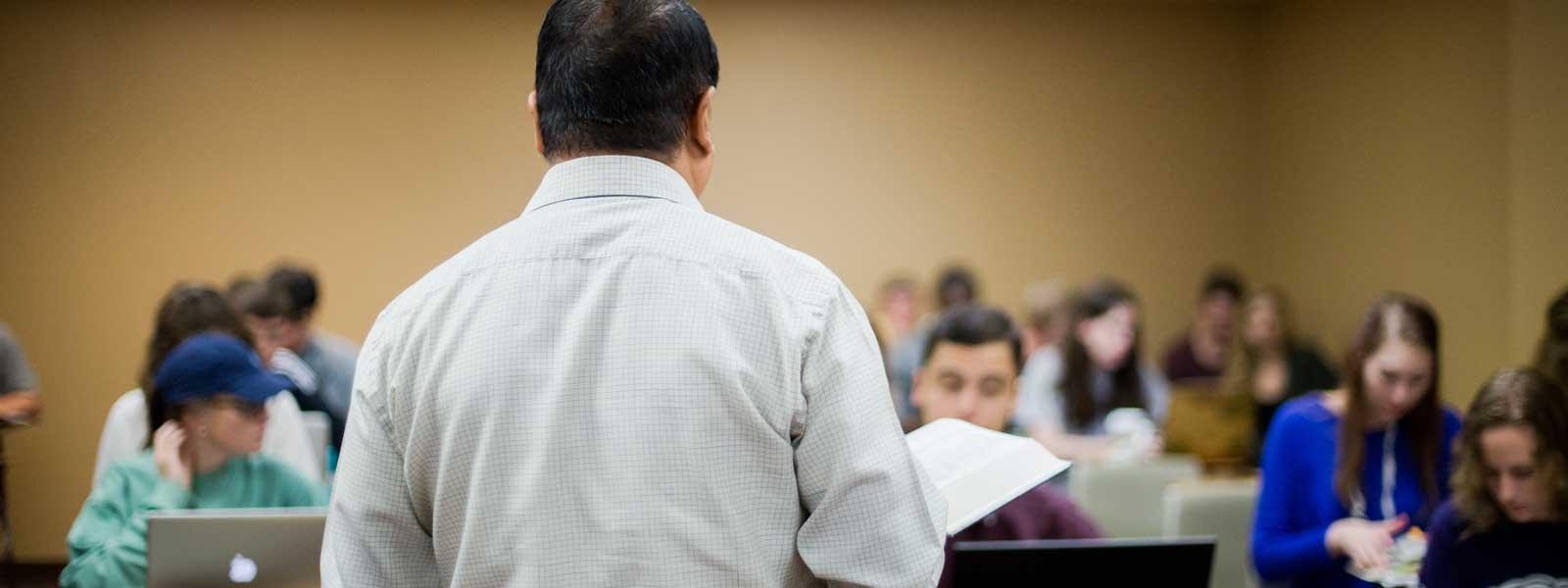 view from behind professor as he lectures to class