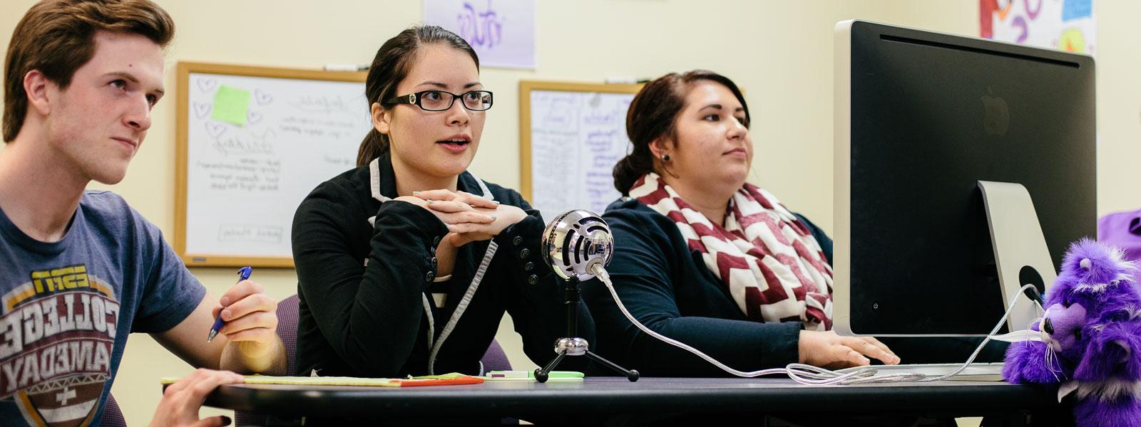 students recording podcast using Mac computer